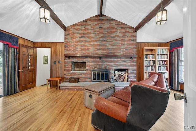 7569 Northfield Ln, Manlius, NY 13104 - living room featuring wood walls, beam ceiling, wood finished floors, a brick fireplace, and high vaulted ceiling