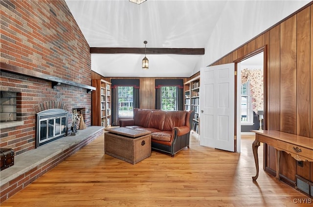 7569 Northfield Ln, Manlius, NY 13104 - living room with light wood finished floors, a brick fireplace, and wooden walls