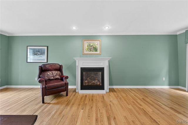 7569 Northfield Ln, Manlius, NY 13104 - sitting room featuring crown molding, a glass covered fireplace, wood finished floors, and recessed lighting