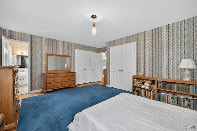 7569 Northfield Ln, Manlius, NY 13104 - bedroom with wallpapered walls, two closets, wood finished floors, and connected bathroom