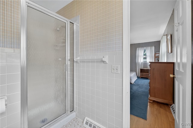 7569 Northfield Ln, Manlius, NY 13104 - full bathroom with a shower stall, wood finished floors, wallpapered walls, connected bathroom, and tile walls