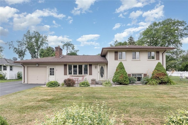 17 Francine Dr, Gates, NY 14606 - tri-level home with an attached garage, a chimney, and asphalt driveway