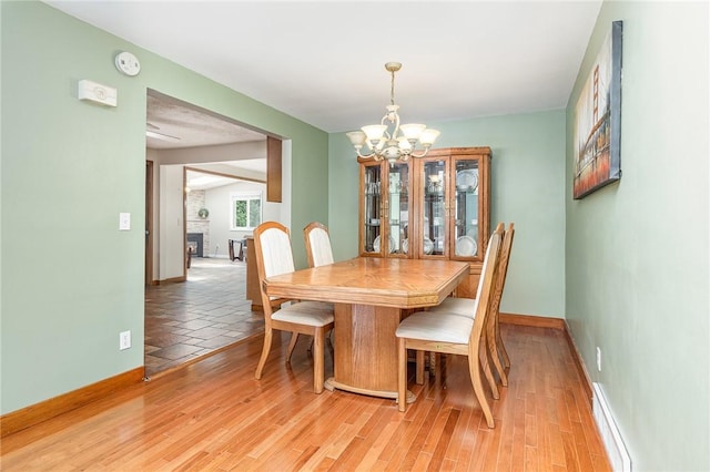 17 Francine Dr, Gates, NY 14606 - dining area with a chandelier and light wood-style floors