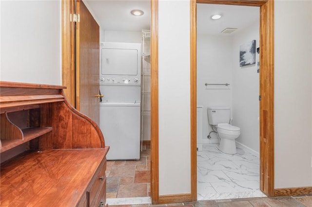 17 Francine Dr, Gates, NY 14606 - washroom with estacked washer and dryer and marble look tile flooring