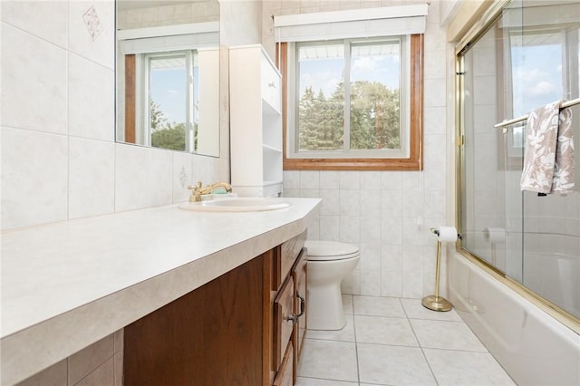 17 Francine Dr, Gates, NY 14606 - bathroom featuring tile walls, vanity, tile patterned flooring, and combined bath / shower with glass door