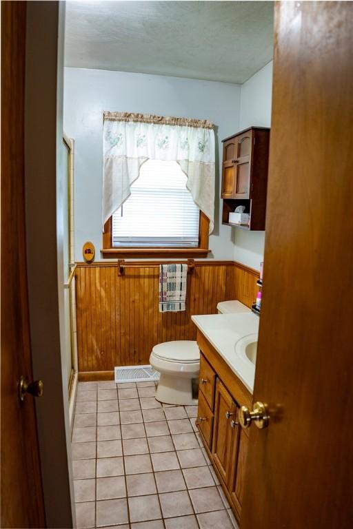 3 Willow Dr, Erwin, NY 14870 - bathroom with wainscoting, a stall shower, tile patterned flooring, wood walls, and vanity