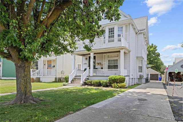 2469 Seneca St, West Seneca, NY 14210 - view of front of property with covered porch, a front lawn, an outbuilding, a balcony, and a detached garage