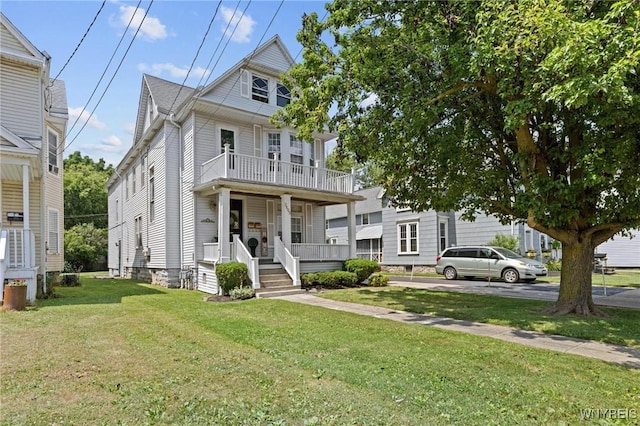 2469 Seneca St, West Seneca, NY 14210 - traditional style home featuring covered porch, a front yard, and a balcony