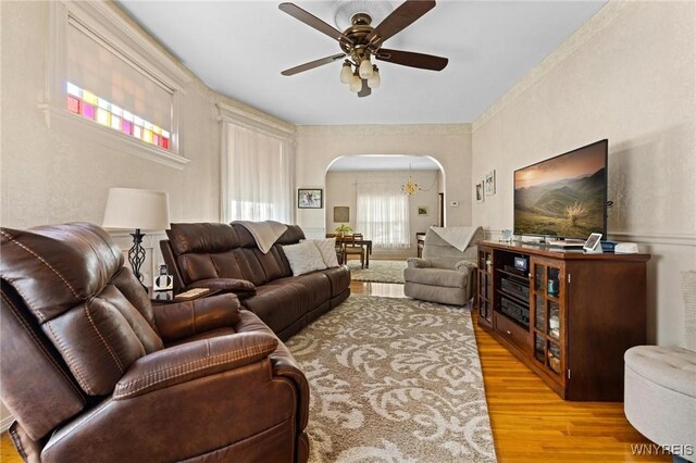 2469 Seneca St, West Seneca, NY 14210 - living area featuring arched walkways, wood finished floors, and ceiling fan