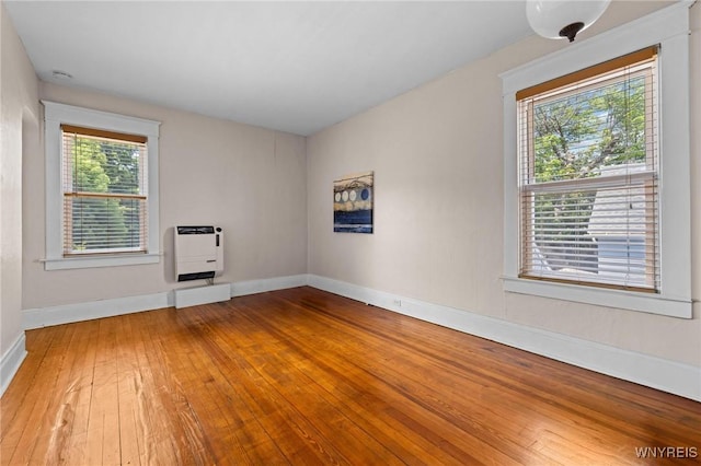 2469 Seneca St, West Seneca, NY 14210 - spare room featuring heating unit and hardwood / wood-style flooring