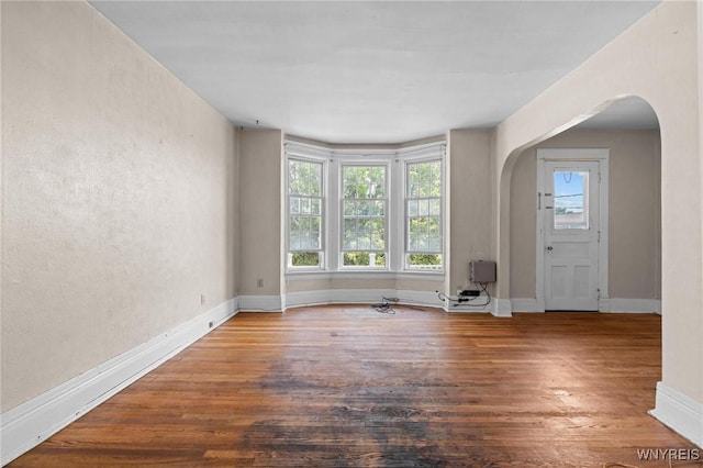 2469 Seneca St, West Seneca, NY 14210 - spare room featuring arched walkways and wood finished floors
