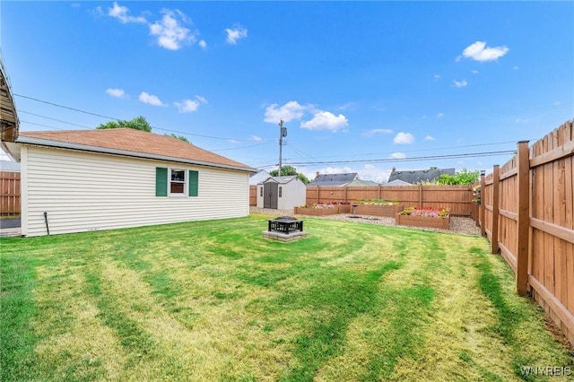 159 Beale Ave, Cheektowaga, NY 14225 - fenced backyard with a storage unit, a garden, and a fire pit