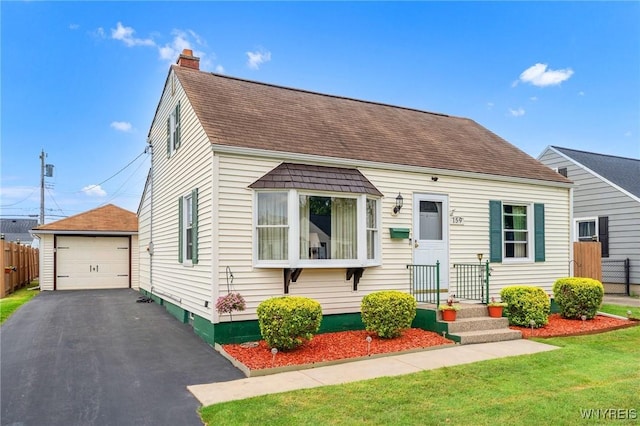 159 Beale Ave, Cheektowaga, NY 14225 - cape cod house with an outdoor structure, a detached garage, a chimney, asphalt driveway, and a shingled roof