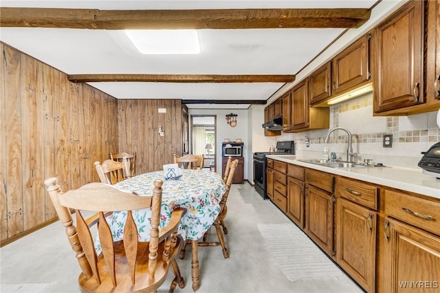 159 Beale Ave, Cheektowaga, NY 14225 - kitchen featuring black range with gas stovetop, beam ceiling, wooden walls, tasteful backsplash, and light countertops