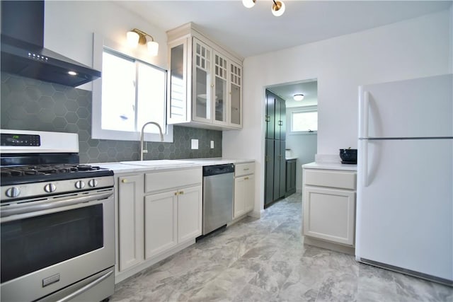 360 Ellison St, Rochester, NY 14609 - kitchen with stainless steel appliances, wall chimney range hood, light countertops, tasteful backsplash, and light marble finish floors