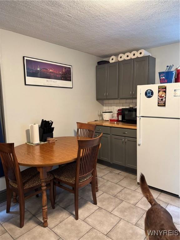 51 Ashton Pl, Buffalo, NY 14220 - dining space featuring a textured ceiling and light tile patterned flooring