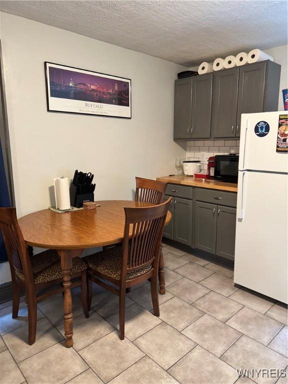 51 Ashton Pl, Buffalo, NY 14220 - dining space featuring a textured ceiling and light tile patterned floors
