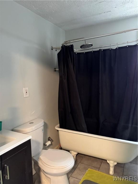 51 Ashton Pl, Buffalo, NY 14220 - full bathroom with a textured ceiling, vanity, tile patterned flooring, and shower / tub combo