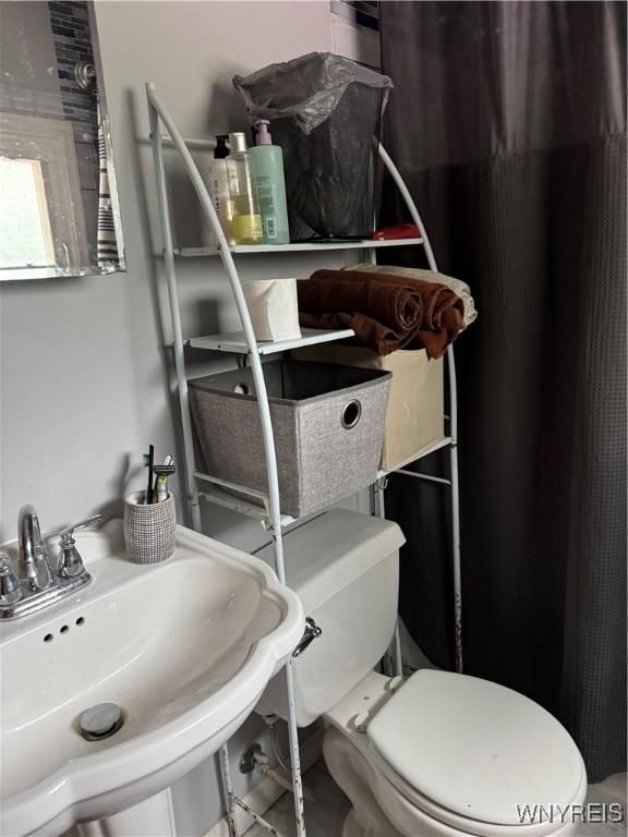 51 Ashton Pl, Buffalo, NY 14220 - bathroom with toilet and a shower with shower curtain
