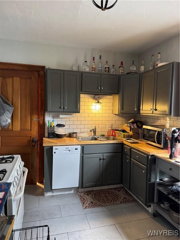 51 Ashton Pl, Buffalo, NY 14220 - kitchen featuring white appliances, backsplash, light tile patterned flooring, and butcher block counters