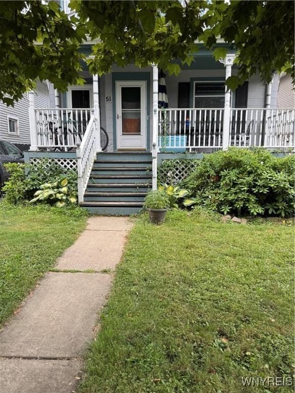 51 Ashton Pl, Buffalo, NY 14220 - entrance to property with covered porch and a lawn