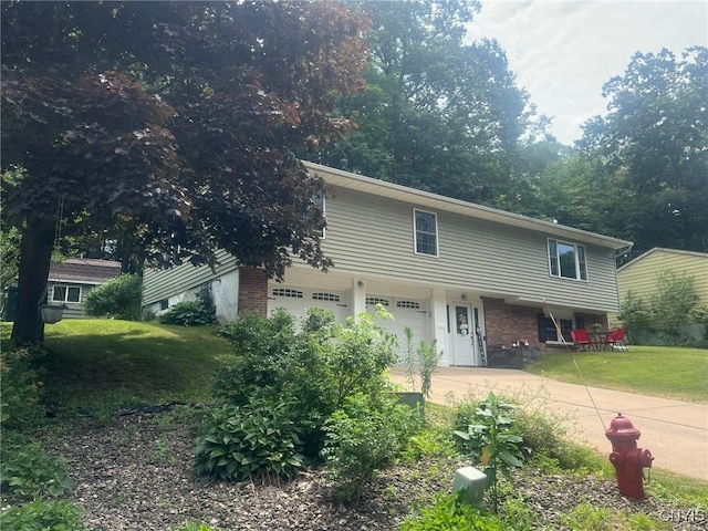 20 Pond Path, Oswego, NY 13126 - view of front of property with driveway, a front lawn, brick siding, and a garage