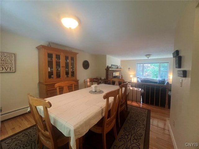 20 Pond Path, Oswego, NY 13126 - dining room featuring a baseboard heating unit and light wood finished floors