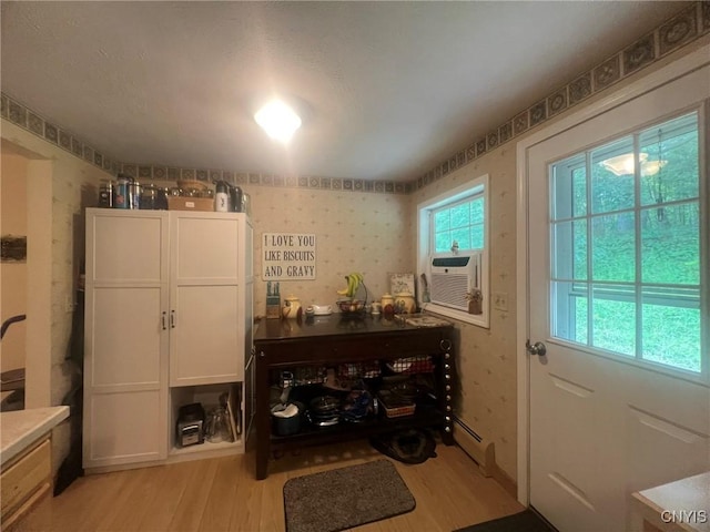 20 Pond Path, Oswego, NY 13126 - doorway with light wood finished floors, wallpapered walls, cooling unit, and baseboard heating