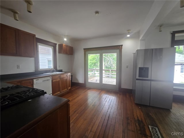 826 Lancaster Ave, Syracuse, NY 13210 - kitchen with white dishwasher, dark countertops, plenty of natural light, and dark wood-style flooring