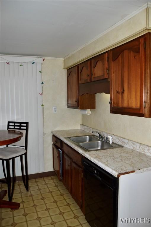 77 Harlem Rd, West Seneca, NY 14224 - kitchen with black dishwasher, light floors, light countertops, and ornamental molding