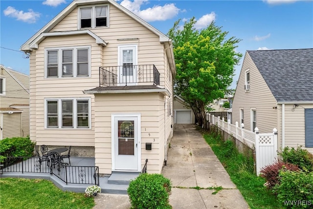 153 Hinman Ave, Buffalo, NY 14216 - view of front of house with a balcony, driveway, and an outbuilding