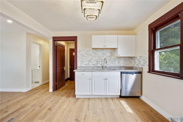 153 Hinman Ave, Buffalo, NY 14216 - kitchen with stainless steel dishwasher, white cabinetry, decorative backsplash, and light wood finished floors