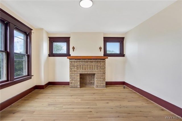 153 Hinman Ave, Buffalo, NY 14216 - unfurnished living room featuring light wood-style floors and a fireplace