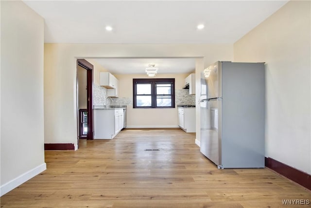 153 Hinman Ave, Buffalo, NY 14216 - kitchen featuring freestanding refrigerator, white cabinets, tasteful backsplash, and recessed lighting