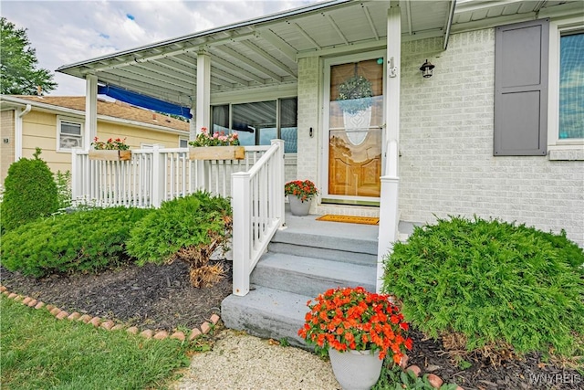 24 Ceil Dr, Cheektowaga, NY 14227 - doorway to property featuring brick siding and a porch
