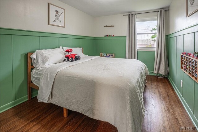 24 Ceil Dr, Cheektowaga, NY 14227 - bedroom featuring wood finished floors, a decorative wall, and wainscoting