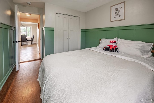 24 Ceil Dr, Cheektowaga, NY 14227 - bedroom featuring wood finished floors, a closet, and a wainscoted wall