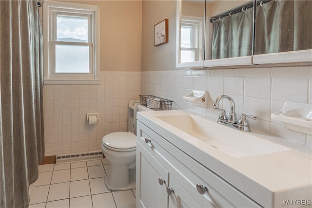 24 Ceil Dr, Cheektowaga, NY 14227 - full bathroom featuring tile patterned floors, vanity, tile walls, a wainscoted wall, and a shower with shower curtain