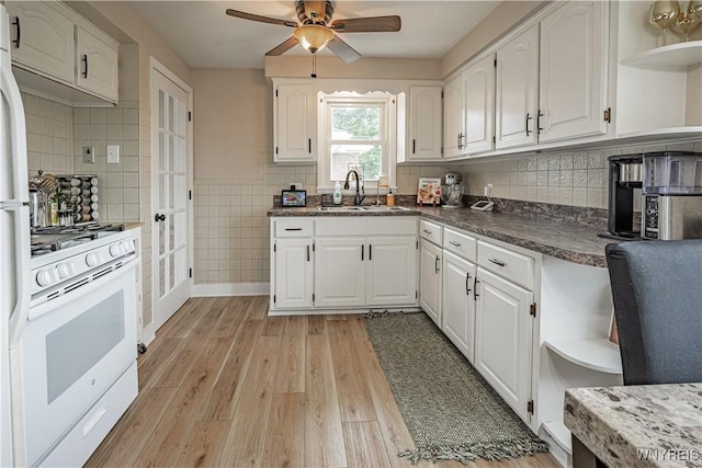 24 Ceil Dr, Cheektowaga, NY 14227 - kitchen with open shelves, white range with gas cooktop, a ceiling fan, white cabinetry, and light wood-style floors