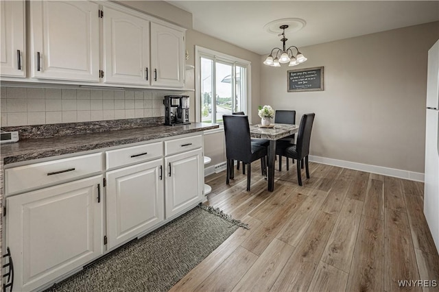 24 Ceil Dr, Cheektowaga, NY 14227 - dining area with light wood-style floors and a chandelier