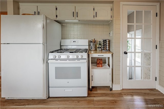 24 Ceil Dr, Cheektowaga, NY 14227 - kitchen featuring white appliances, white cabinets, light wood-style floors, decorative backsplash, and exhaust hood