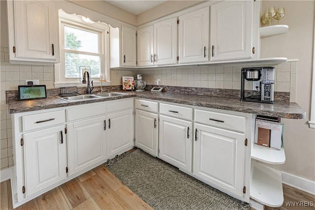 24 Ceil Dr, Cheektowaga, NY 14227 - kitchen with open shelves, dark countertops, light wood-style flooring, and white cabinetry