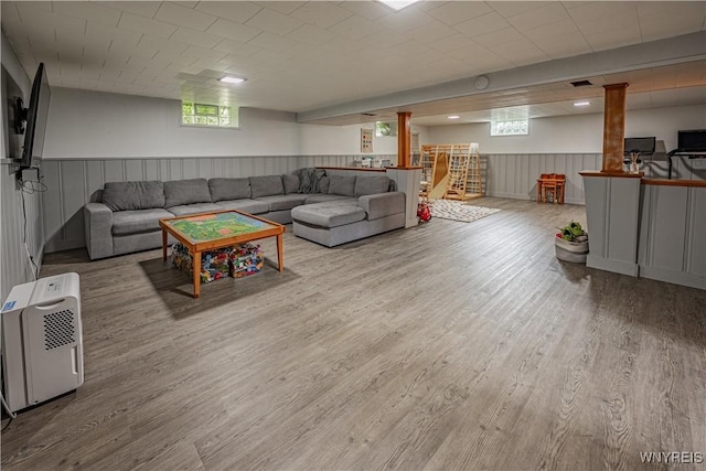 24 Ceil Dr, Cheektowaga, NY 14227 - living area featuring wood finished floors, plenty of natural light, and wainscoting