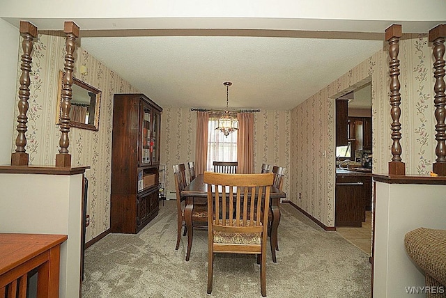 4 Windtree Ln, West Seneca, NY 14224 - dining area with wallpapered walls, light carpet, and a chandelier