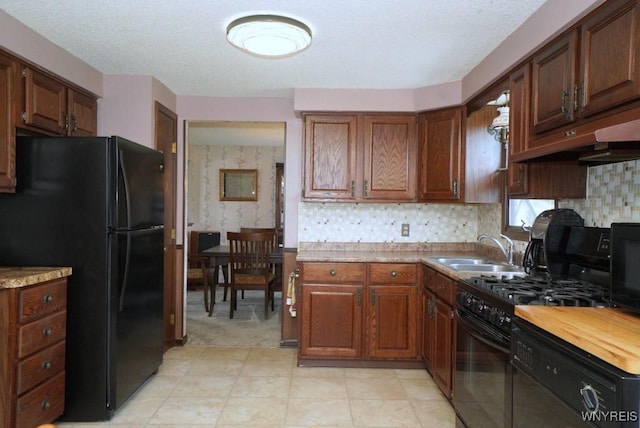 4 Windtree Ln, West Seneca, NY 14224 - kitchen featuring black appliances, tasteful backsplash, and under cabinet range hood