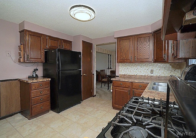 4 Windtree Ln, West Seneca, NY 14224 - kitchen with freestanding refrigerator, a textured ceiling, tasteful backsplash, and exhaust hood