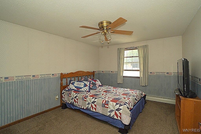 4 Windtree Ln, West Seneca, NY 14224 - bedroom with a baseboard radiator, wainscoting, carpet flooring, wallpapered walls, and a ceiling fan
