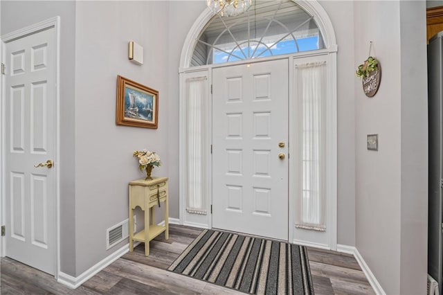 65 Sotheby Dr, Greece, NY 14626 - entryway with dark wood-type flooring and a chandelier