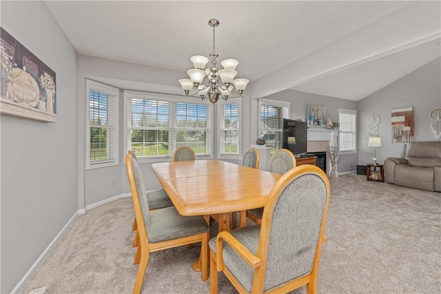 65 Sotheby Dr, Greece, NY 14626 - carpeted dining area featuring a chandelier, healthy amount of natural light, lofted ceiling, and a fireplace