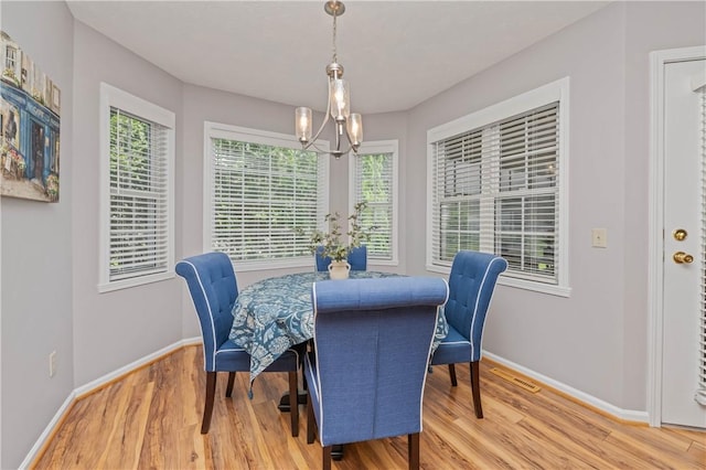 65 Sotheby Dr, Greece, NY 14626 - dining space featuring a chandelier, light wood-style floors, and healthy amount of natural light